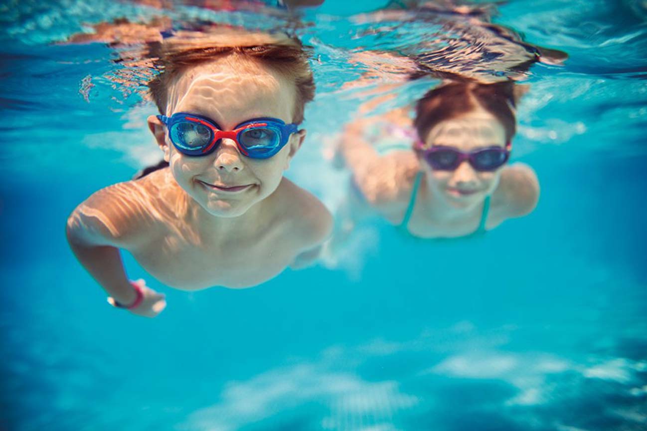 children smiling underwater
