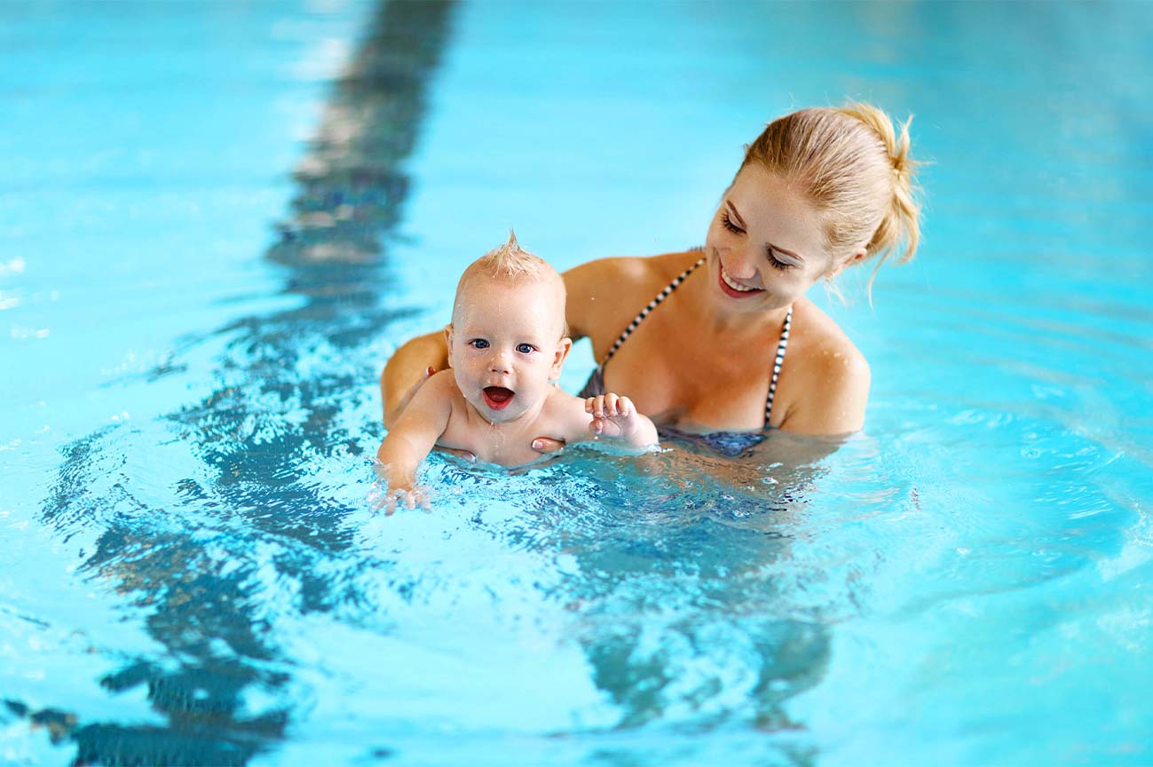 mother and baby swimming in a pool